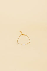 Pulsera Osja con incrustación de perla blanca y oro de 14 quilates